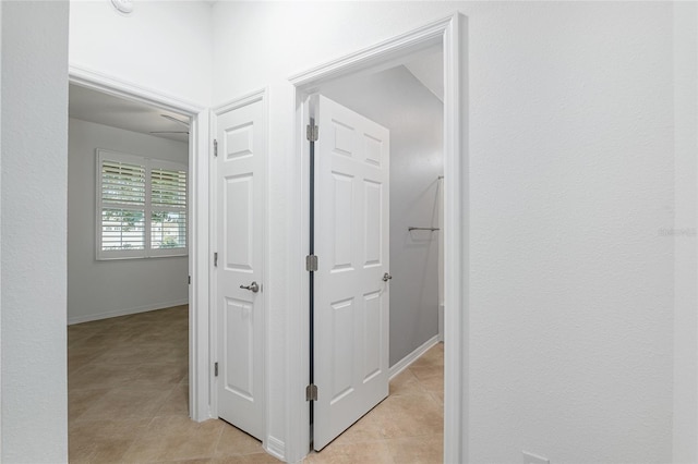 corridor featuring light tile patterned floors