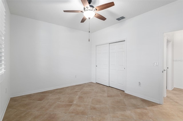 unfurnished bedroom with a closet, ceiling fan, and light tile patterned floors