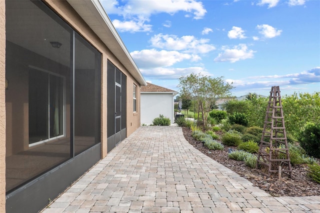 view of patio / terrace featuring a sunroom