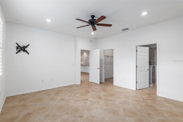 7709 SW 86th Ct, Ocala, FL 34481 - unfurnished bedroom featuring a walk in closet, recessed lighting, baseboards, and ceiling fan
