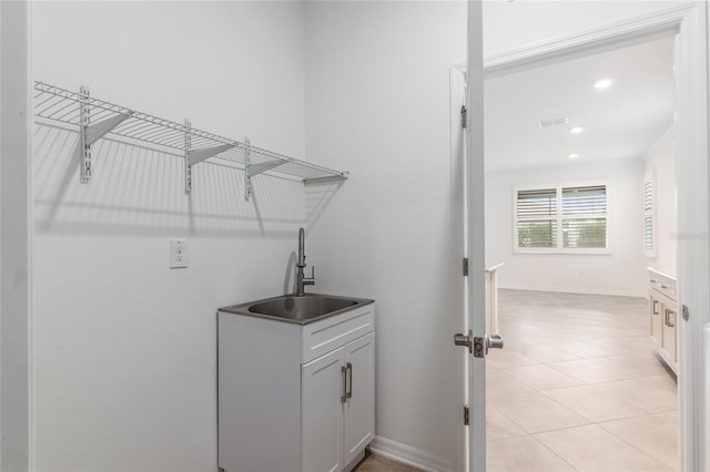 7709 SW 86th Ct, Ocala, FL 34481 - laundry area with a sink, recessed lighting, light tile patterned floors, and baseboards