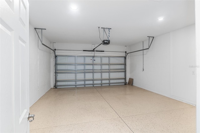 7709 SW 86th Ct, Ocala, FL 34481 - garage with recessed lighting, concrete block wall, and a garage door opener