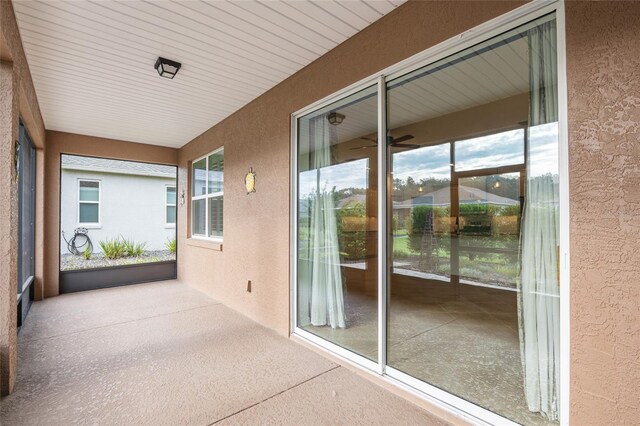 7709 SW 86th Ct, Ocala, FL 34481 - unfurnished sunroom with a textured wall, plenty of natural light, speckle patterned floor, and a ceiling fan
