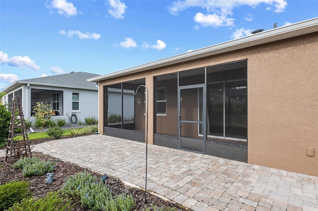 7709 SW 86th Ct, Ocala, FL 34481 - back of house featuring a sunroom, stucco siding, and a patio area