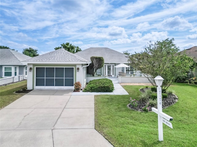 ranch-style home with a garage and a front lawn