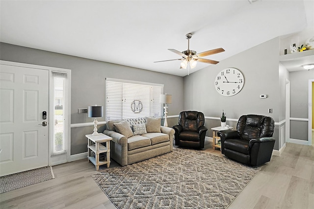 living room featuring ceiling fan, plenty of natural light, and light hardwood / wood-style floors