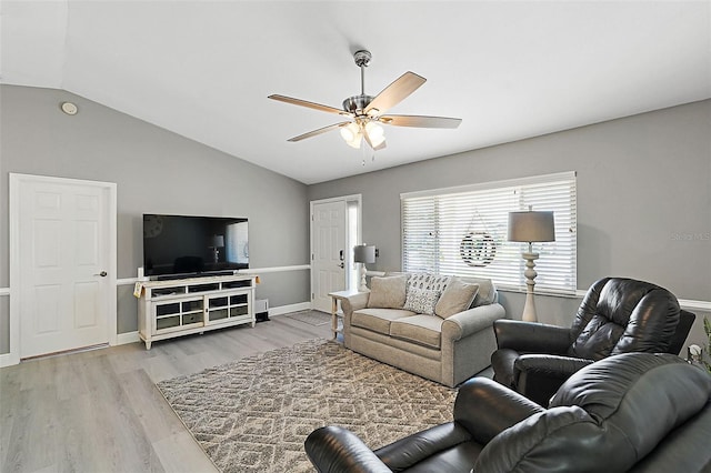 living room featuring ceiling fan, light hardwood / wood-style floors, and lofted ceiling