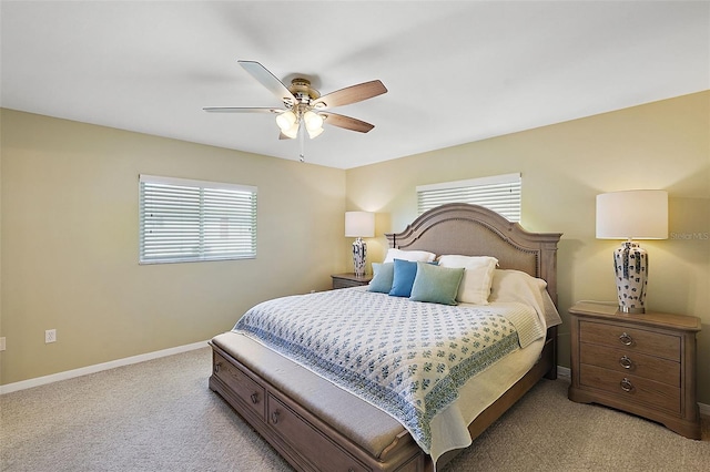 carpeted bedroom with multiple windows and ceiling fan