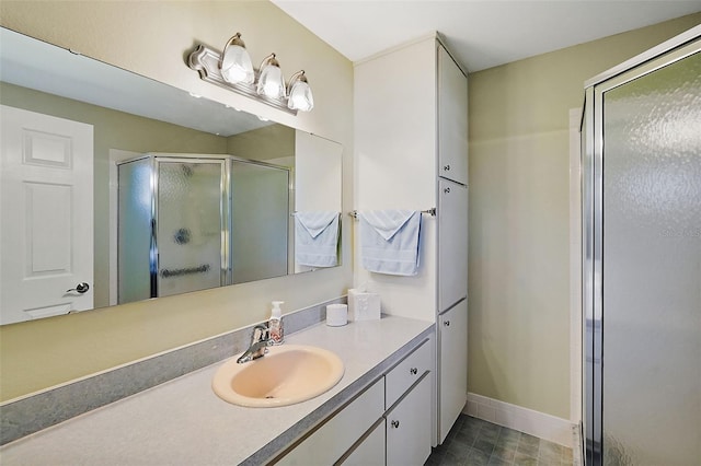 bathroom with vanity and a shower with door