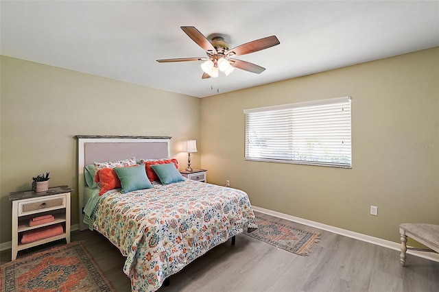 bedroom with hardwood / wood-style flooring and ceiling fan