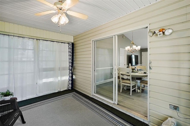 sunroom with ceiling fan with notable chandelier