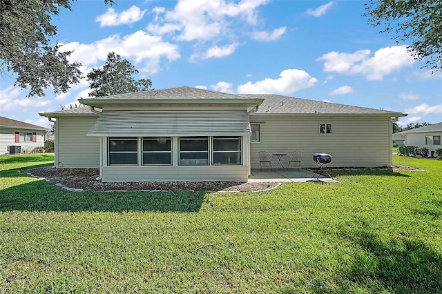 rear view of property featuring a lawn, central AC unit, and a patio area