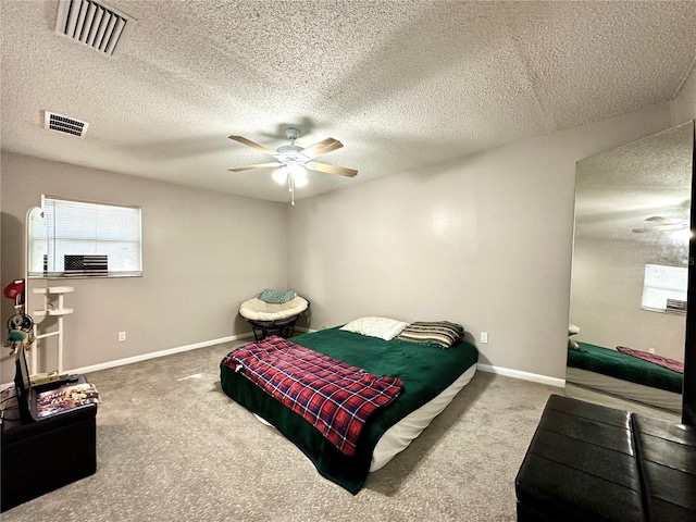 bedroom featuring ceiling fan, a textured ceiling, and carpet flooring