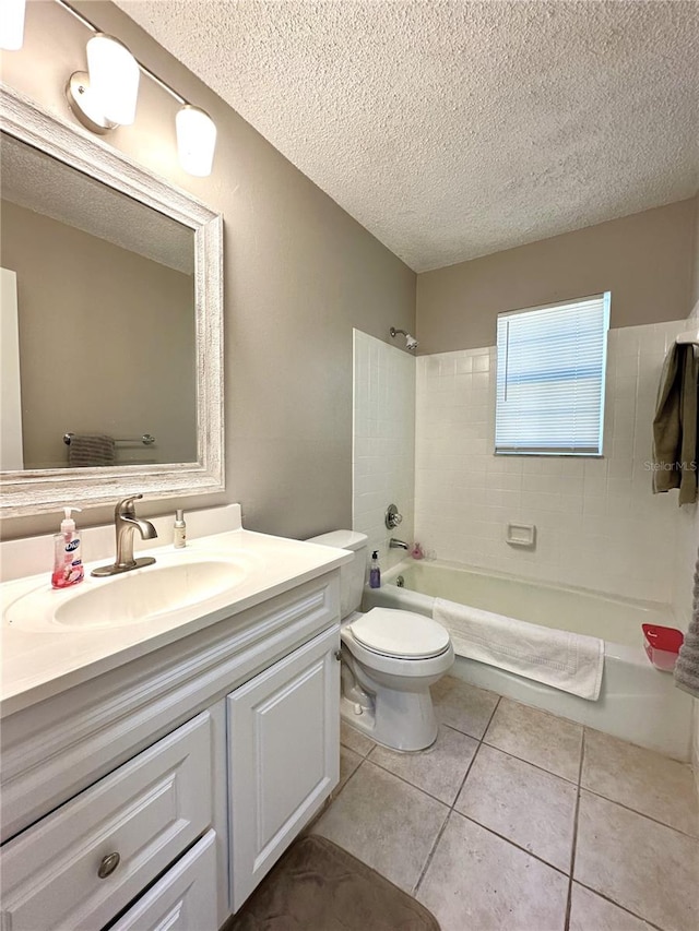 full bathroom with vanity, a textured ceiling, tiled shower / bath combo, tile patterned flooring, and toilet