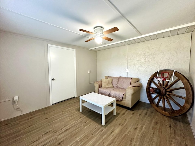 living room with wood-type flooring and ceiling fan