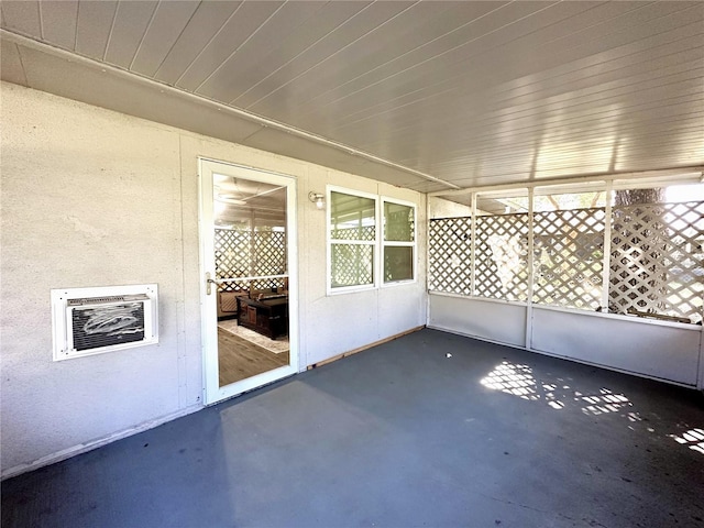 unfurnished sunroom with heating unit