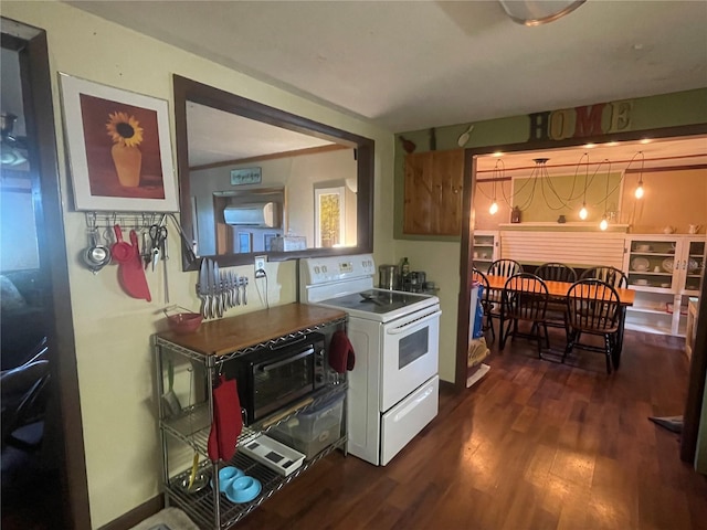 kitchen featuring a toaster, white electric range oven, and dark wood-style flooring