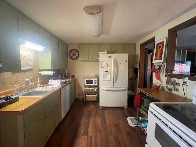 kitchen featuring dark wood-type flooring, sink, and white appliances