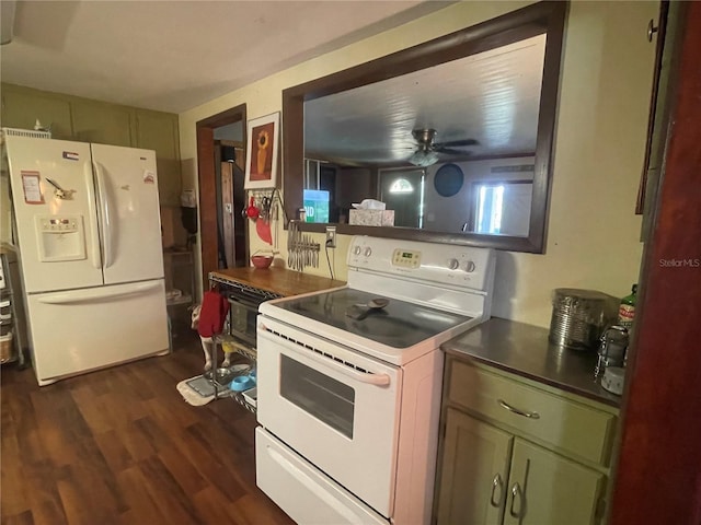 kitchen with white appliances, a ceiling fan, dark countertops, and dark wood-style floors