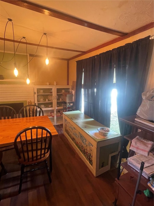 bedroom featuring wood finished floors and beam ceiling