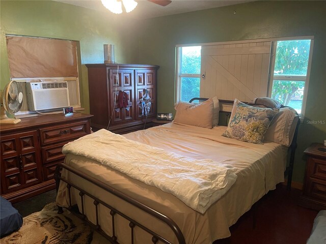 bedroom with cooling unit and ceiling fan