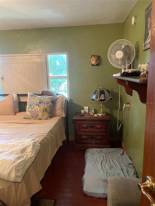 bedroom with dark wood-type flooring