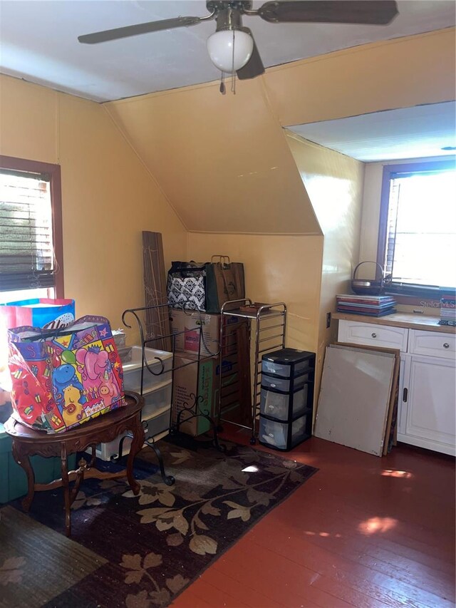 additional living space with ceiling fan, vaulted ceiling, and dark wood-type flooring