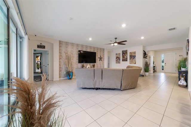 living room with ceiling fan and light tile patterned floors