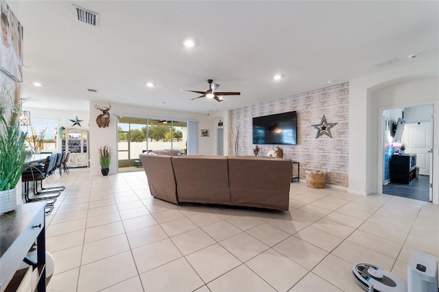 tiled living room featuring ceiling fan