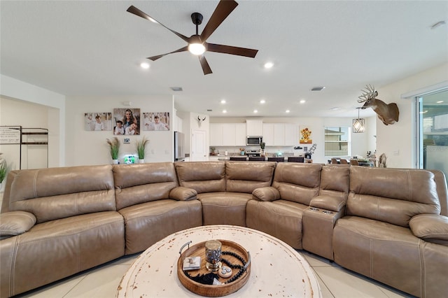 living room featuring light tile patterned floors and ceiling fan