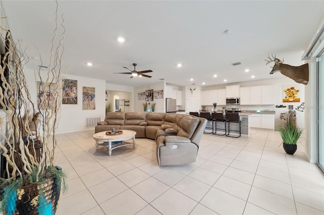 tiled living room featuring ceiling fan