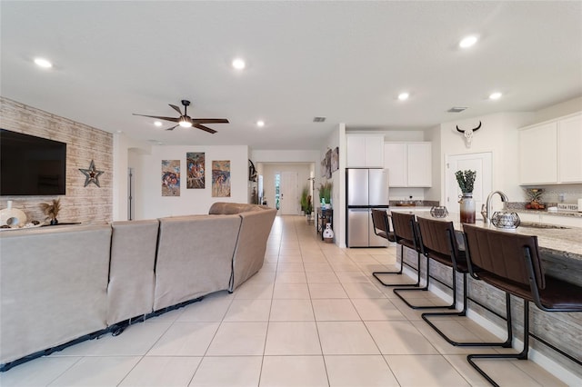 tiled living room featuring ceiling fan