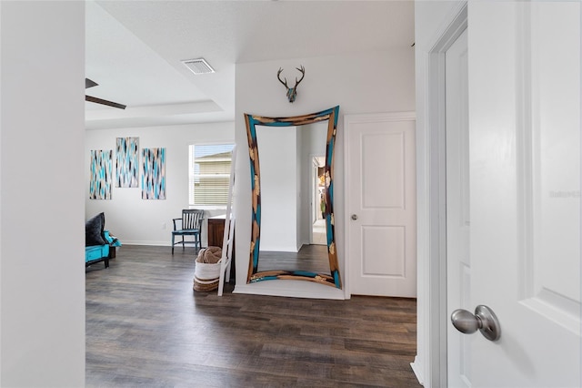 foyer with ceiling fan and dark wood-type flooring