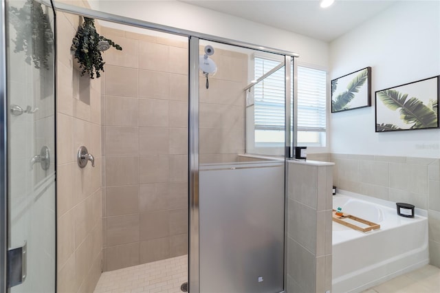 bathroom featuring tile patterned flooring and independent shower and bath