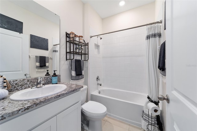 full bathroom featuring shower / bath combo with shower curtain, tile patterned floors, vanity, and toilet