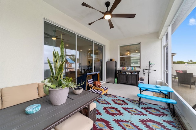 sunroom / solarium featuring a wealth of natural light and ceiling fan