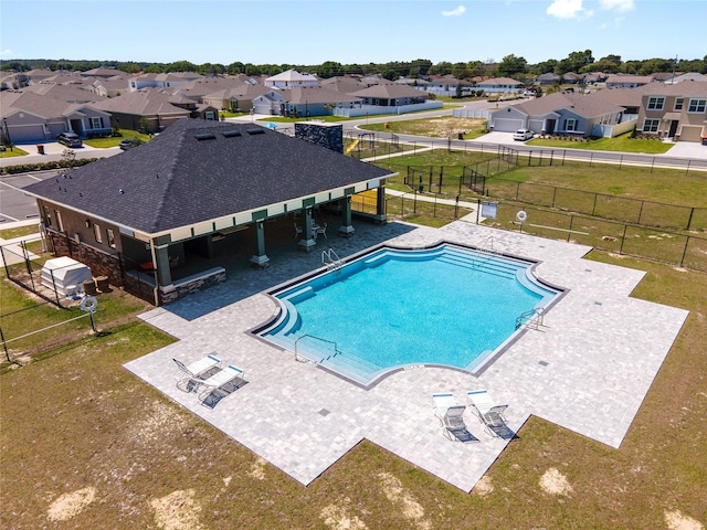 view of swimming pool featuring a lawn and a patio area