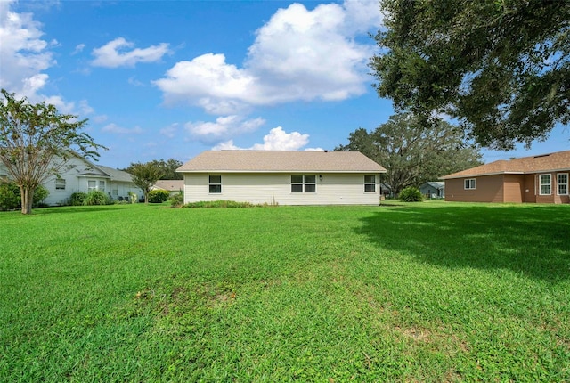 back of property featuring a lawn