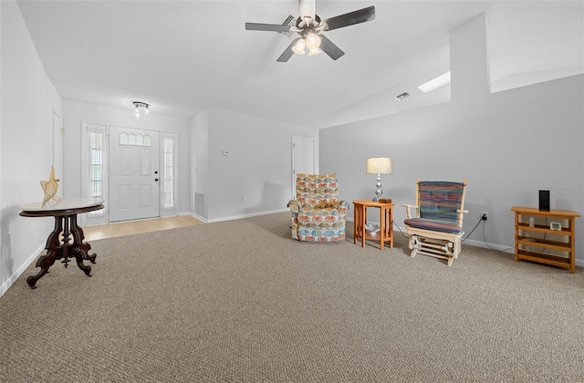 sitting room with ceiling fan and light colored carpet