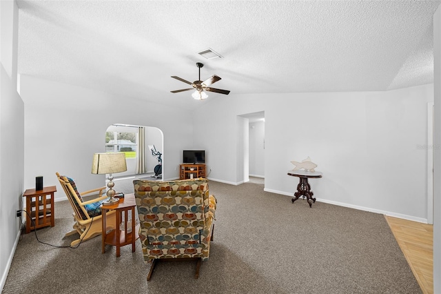 sitting room featuring wood-type flooring, a textured ceiling, ceiling fan, and lofted ceiling