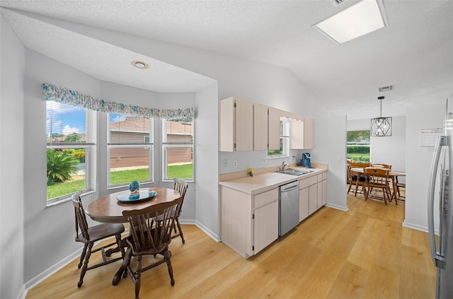 kitchen featuring sink, light hardwood / wood-style flooring, decorative light fixtures, a healthy amount of sunlight, and stainless steel appliances