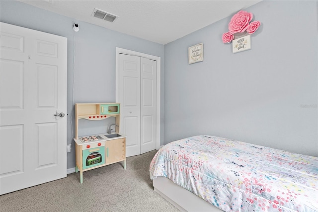 carpeted bedroom with a closet