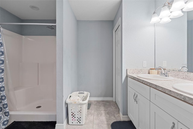 bathroom with a shower with curtain, vanity, and tile patterned floors