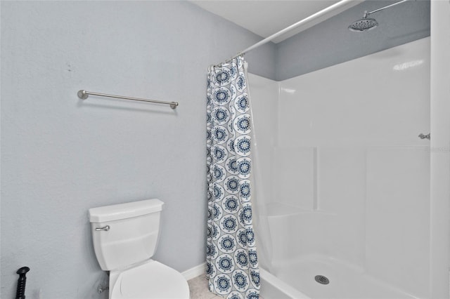 bathroom with walk in shower and toilet