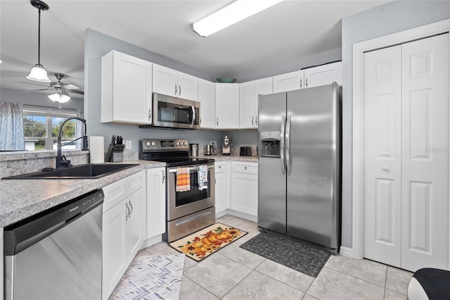 kitchen with white cabinetry, ceiling fan, appliances with stainless steel finishes, and sink