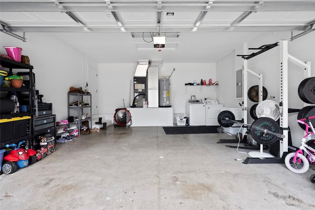 garage with heating unit, electric water heater, a garage door opener, electric panel, and washing machine and clothes dryer