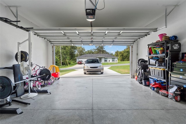 garage featuring a garage door opener and a carport