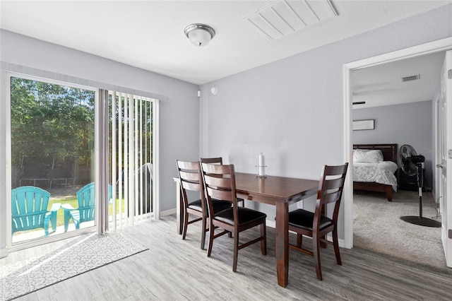 dining space with a healthy amount of sunlight and hardwood / wood-style flooring