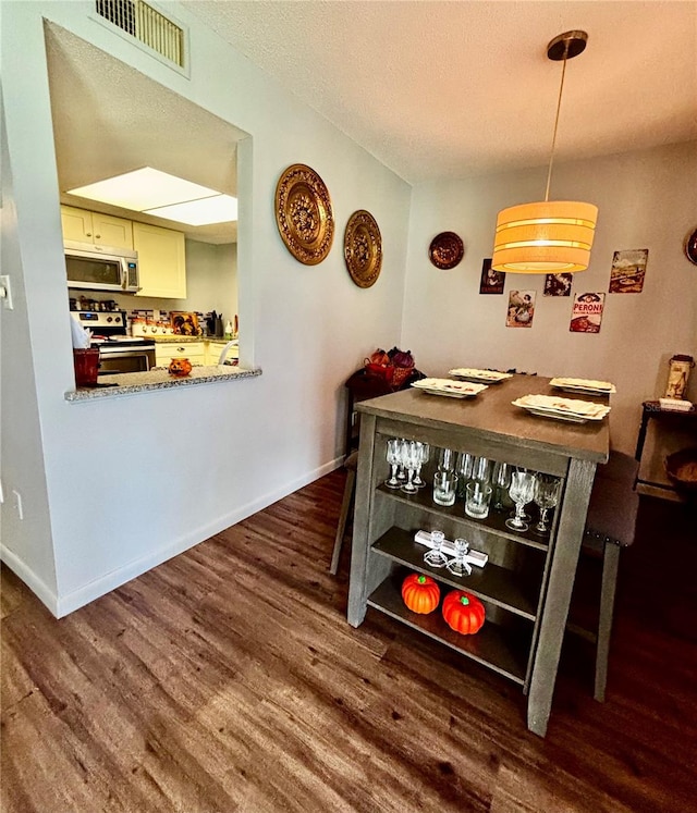 dining space with dark hardwood / wood-style floors