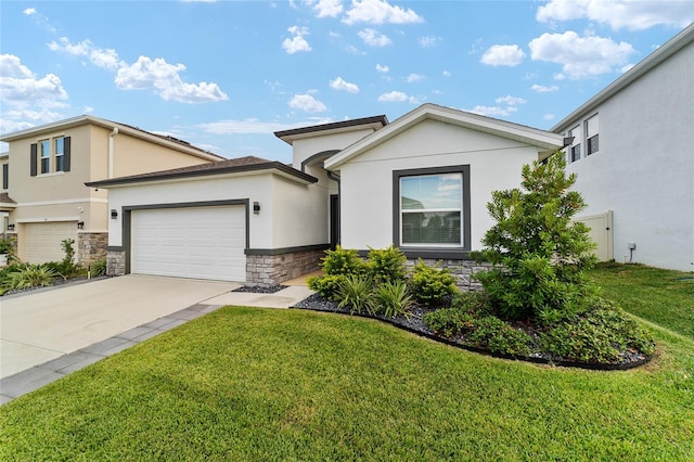 view of front of home with a garage and a front lawn